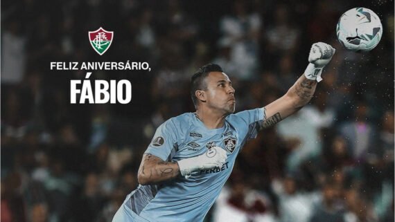 Goleiro Fábio do Fluminense fazendo uma defesa, socando a bola. No canto superior esquerdo, uma mensagem escrito: 