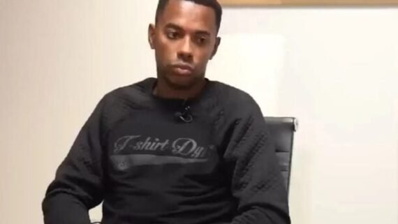 Ex-jogador de futebol Robinho sentado olhando para baixo de moletom preto (foto: Foto: Reprodução/Globoplay)